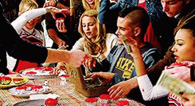Group Around Table With Man In Nike Sweatshirt GIF