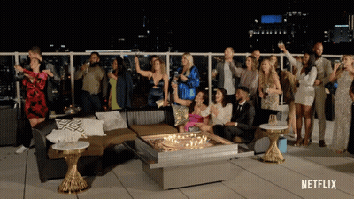 Group Around Table With Netflix Logo GIF