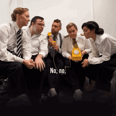 Group Around Yellow Telephone Saying No No GIF