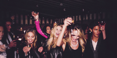 Group Dancing at Party Woman Holding Orange Juice