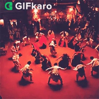 Group Dancing In Circle On Stage In Dark Room GIF