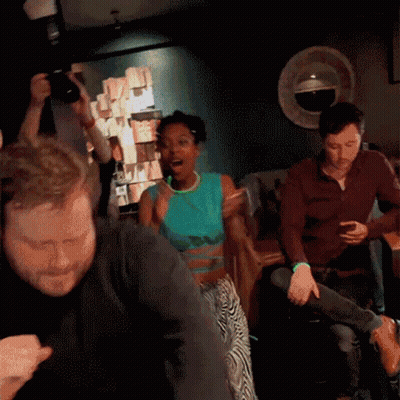 Group Dancing In Dark Room With Man Taking Picture GIF