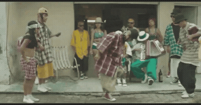 Group Dancing In Front Of Building As Man Holds Accordion GIF