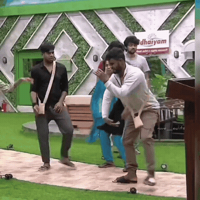 Group Dancing In Front Of Dharmam Sign GIF