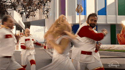 Group Dancing In Front Of Disney Plus Building GIF