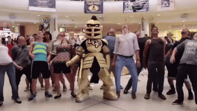 Group Dancing In Front Of Knight Mascot GIF