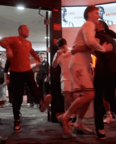 Group Dancing In Front Of Less Shopping Sign GIF