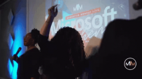 Group Dancing In Front Of Microsoft Screen GIF