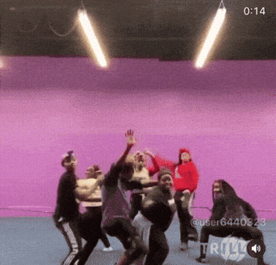 Group Dancing In Front Of Purple Background At 1:14 GIF