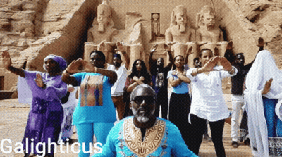 Group Dancing In Front Of Statue Galighticus GIF
