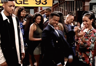 Group Dancing In Front Of Yellow Sign Saying Ge 93 GIF