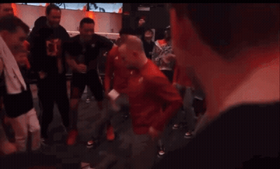 Group Dancing In Room With Red Allianz Sign GIF