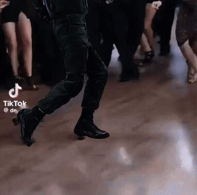 Group Dancing On Dance Floor With TikTok Logo GIF