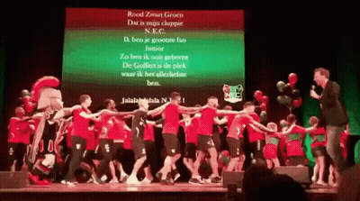 Group Dancing On Stage In Front Of Rood Zwart Groen Screen GIF