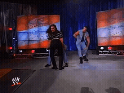 Group Dancing On Stage In Front Of W Sign GIF