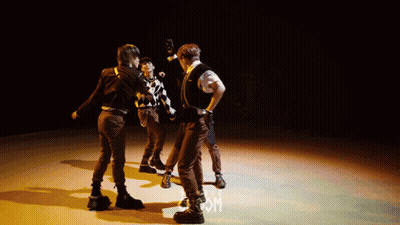 Group Dancing On Stage With Letter M GIF