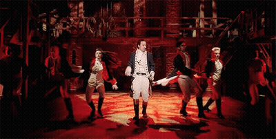 Group Dancing On Stage With Man Holding Sword GIF