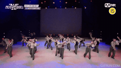 Group Dancing On Stage With Mnet Logo GIF