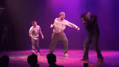 Group Dancing On Stage With Purple Lights GIF
