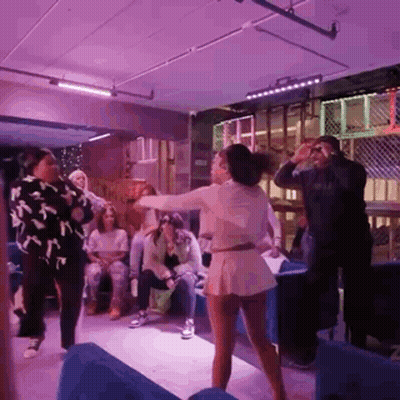 Group Dancing Under Purple Lights GIF