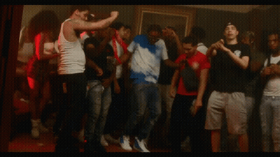 Group Dancing With Man In Tie Dye Shirt With Letter S GIF