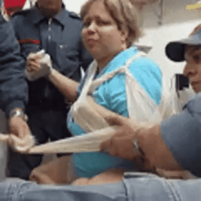Group Helping Woman With Bandage On Arm GIF