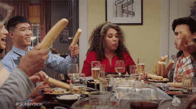 Group Holding Bread Sticks In Air GIF