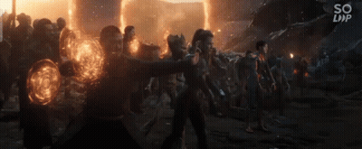 Group Holding Glowing Orbs In Dark Room GIF
