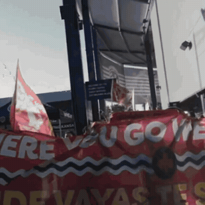 Group Holding Red Banner Saying Ere You Gove GIF