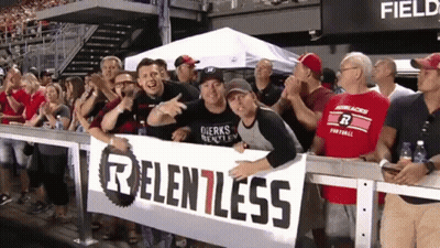 Group Holding Sign Saying Relentless GIF