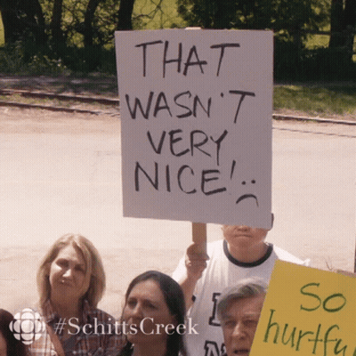 Group Holding Sign That Wasn't Nice GIF