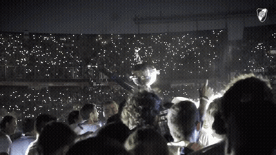 Group Holding Trophy In Stadium With River Plate Logo GIF