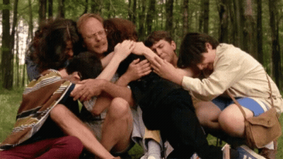 Group Huddled In Circle In Woods GIF