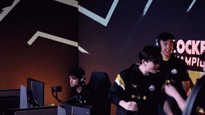 Group Hugging In Front Of Rocke Champions Sign GIF