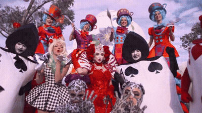 Group In Alice In Wonderland Costumes Posing GIF