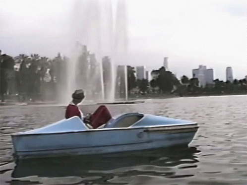 Group In Bikinis Riding Boat On Lake GIF