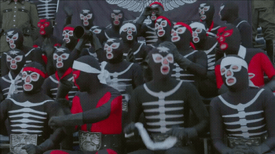 Group In Black And White Masks With Red Headband GIF