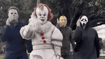 Group In Clown And Scream Masks Standing Together GIF