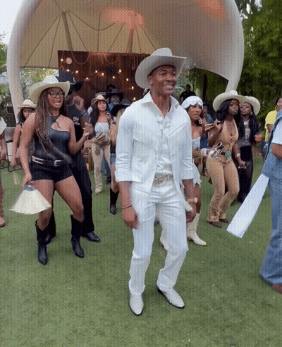 Group In Cowboy Hats Dancing In Field GIF
