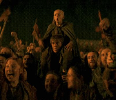 Group In Dark Room Holding Child On Shoulders GIF