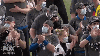 Group in Face Masks and Fox Deportes Shirts Clapping