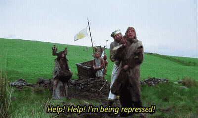 Group In Field Saying Help Help I'm Being Repressed GIF