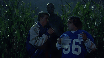 Group In Field With Man In Mask GIF