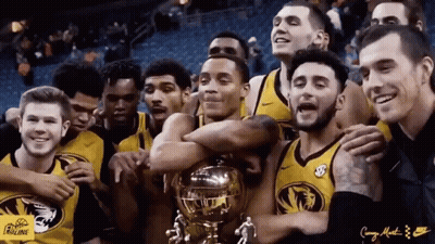 Group In Front Of Drum Set With Big Ten Conference Sign GIF