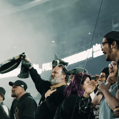 Group In Front Of Full Sign GIF