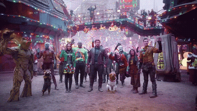 Group In Front Of Guardians Of The Galaxy Sign GIF