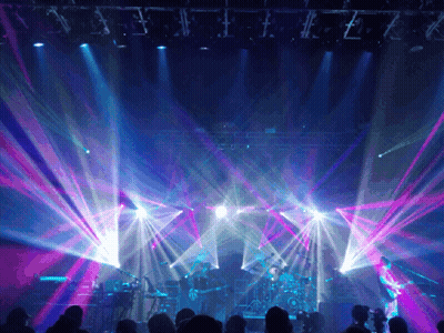 Group In Front Of Lit Stage GIF