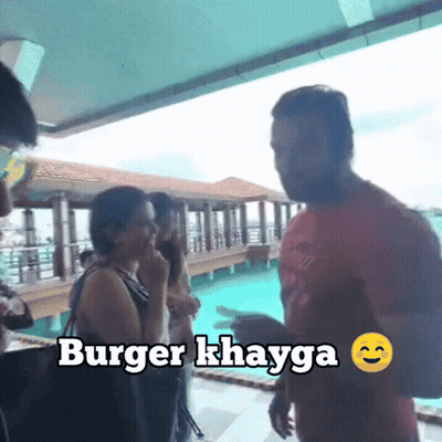 Group In Front Of Swimming Pool With Burger Khayga Sign GIF