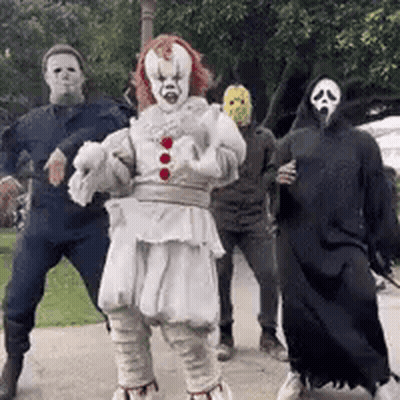 Group in Halloween Costumes Dancing on Sidewalk