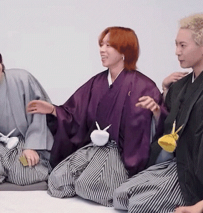 Group In Kimonos Sitting On Floor Talking GIF